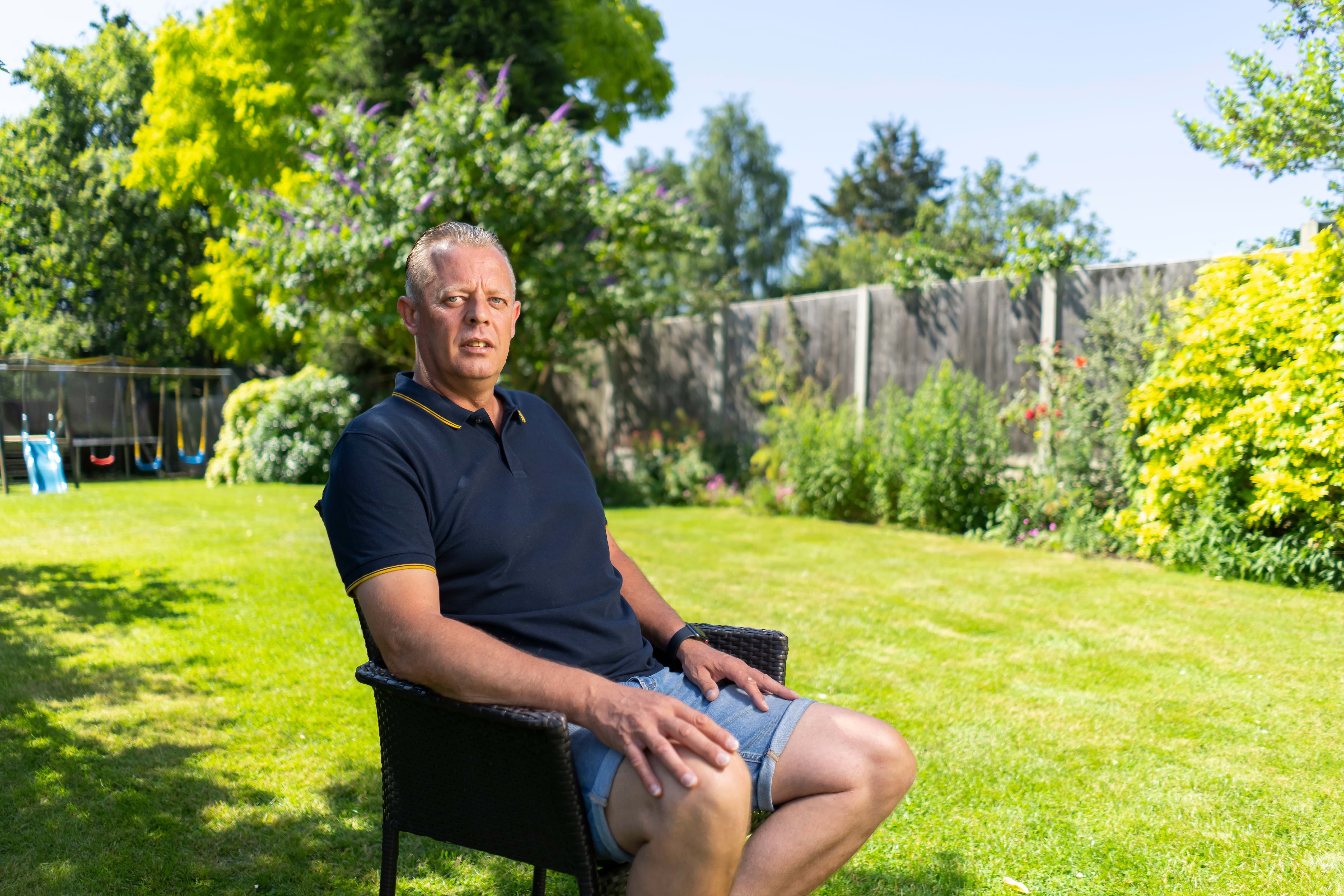 Mark Saunders sat in his garden